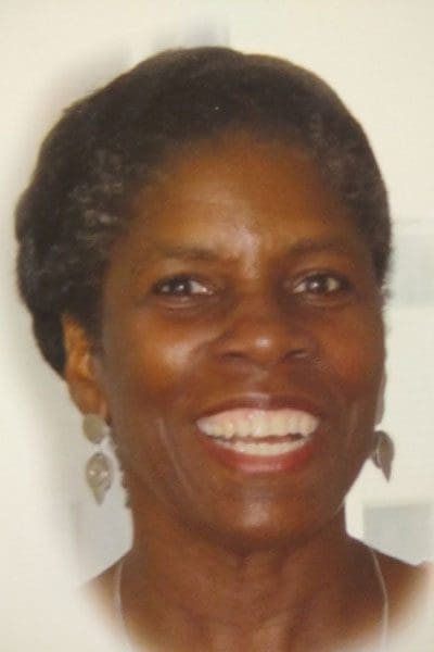 A woman with short hair smiles for the camera.