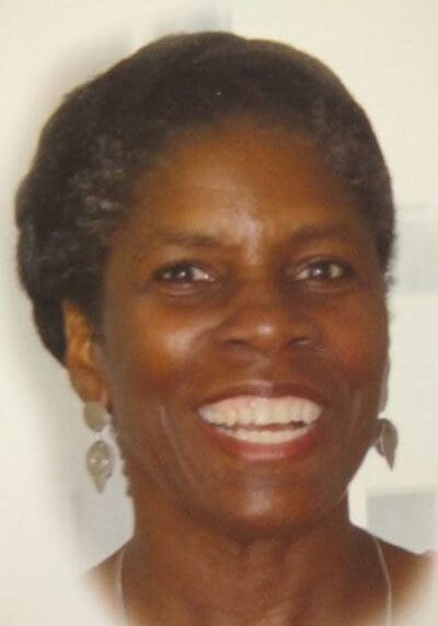 A woman with short hair smiles for the camera.