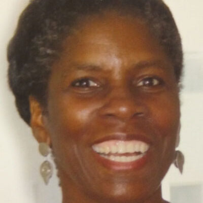 A woman with short hair smiles for the camera.