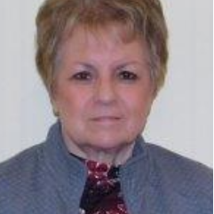 A woman with short hair wearing a tie.